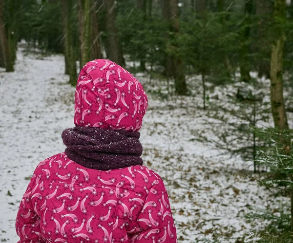 Girl in pink winter clothes. Winter snowy landscape. Active lifestyle. Travel.