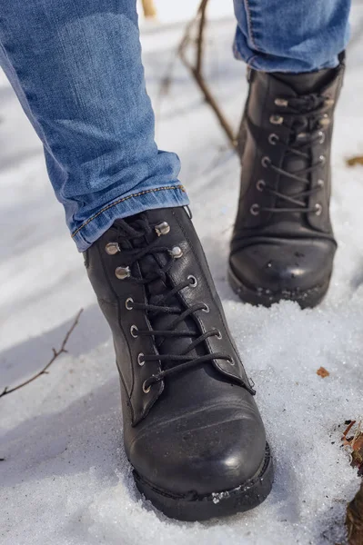 Woman winter boots on snow.