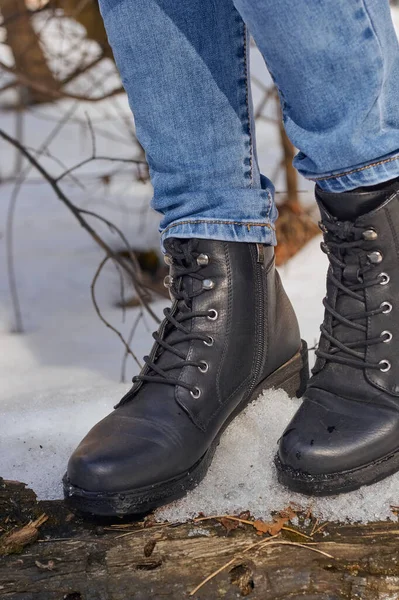 Woman winter boots on snow.