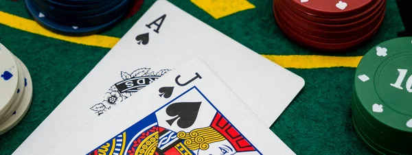 web banner cards with ace and jack of spades, scoring with black jack hand at the gaming table with chips