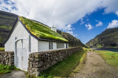 Village church and a lake in Saksun, Faroe Islands, Denmark clipart