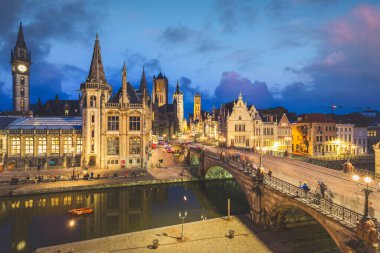 High point of view of Medieval city of Gent in Flanders with Saint Nicholas Church and Gent Town Hall, Belgium. Sunset cityscape of Gent.