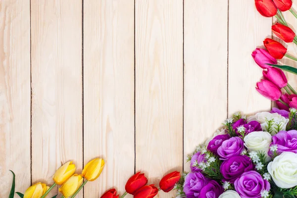 Bouquet white and purple roses. Pink, red, yelow, tulips on wood Stock Photo