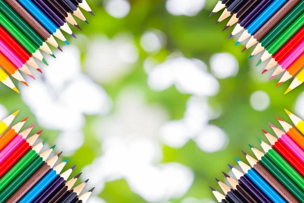 Frame of Colour pencils on Soft green natural bokeh background — Stockfoto