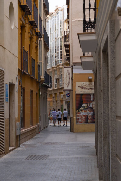Malaga, Spain - June 19, 2021: People walking in the historic center of Malaga in Spain