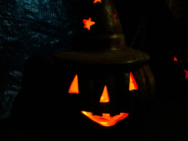 Halloween party decoration pumpkin with hat and fire inside its core to scare