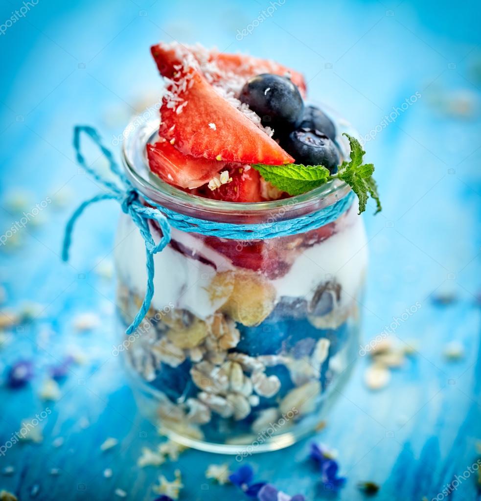 Strawberry blueberry yogurt parfait with addition of muesli, coconut