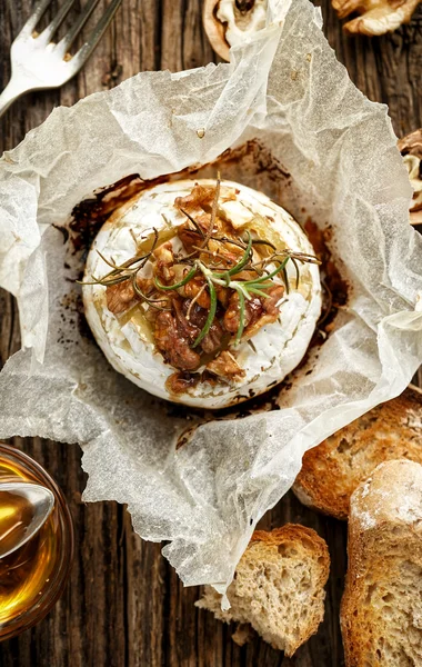 Baked Camembert with walnuts, honey  and rosemary on wooden rustic table — Stock Photo, Image