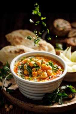 Geleneksel humus zeytinyağı, paprika tozu ve taze maydanoz serpiştirilmiş nohut.