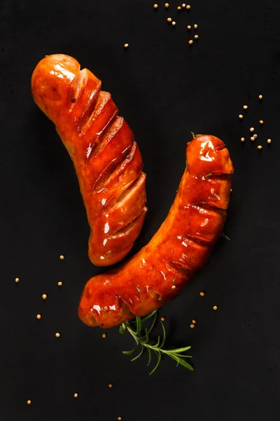 Grilled sausages on black background — Stock Photo, Image