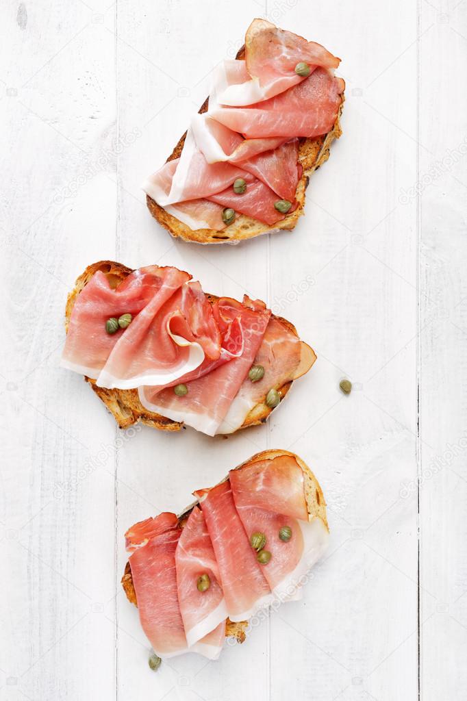 Bruschetta with ham and capers