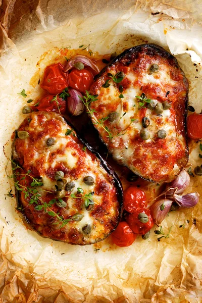 Grilled eggplant stuffed with tomatoes and cheese with capers and herbs — Stock Photo, Image