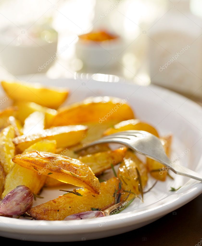 Roasted  potato wedges with addition rosemary and garlic
