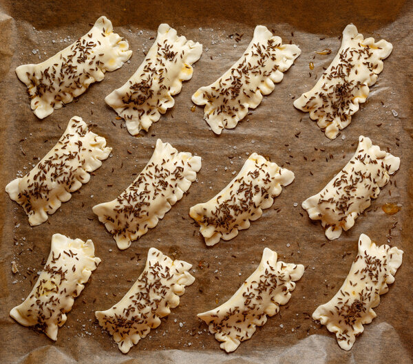 Raw puff pastry stuffed with cabbage and mushrooms before cooking