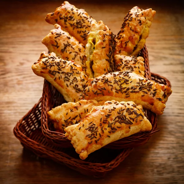 Pasties with puff pastry stuffed with cabbage and mushrooms sprinkled with caraway seeds