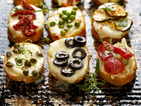 Crostini with different toppings — Stock Photo, Image