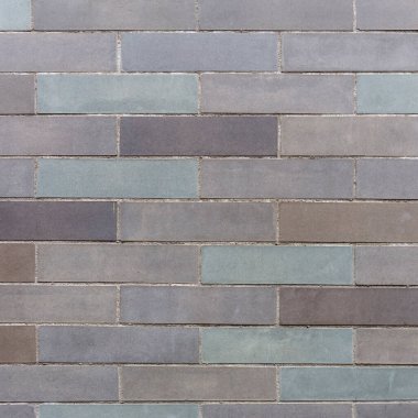 Arka plan olarak farklı boyutlarda tuğlalardan yapılmış taş duvar