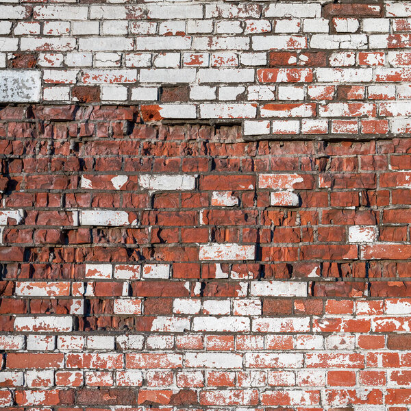 Old brick wall of bricks of different textures as the background