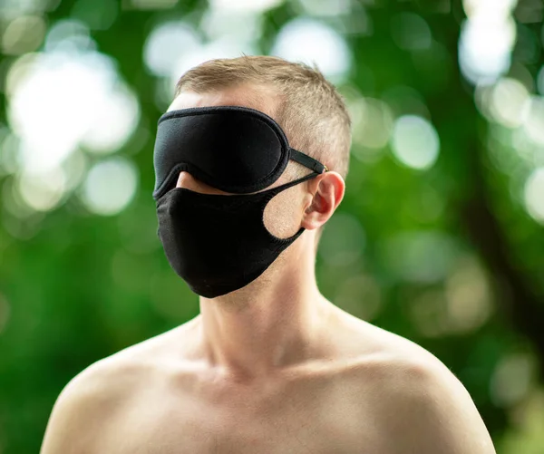 Covid - man. A lonely man during the virus pandemic. The mask becomes his everyday attribute. However, due to limitations in travel and interpersonal contacts, man becomes blind, surrounded by the beauty of nature