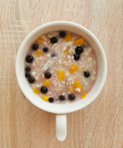 Porridge Oatmeal Orange Pumpkin Blueberries — Stock Photo, Image