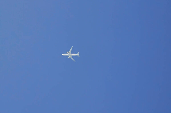 The plane in the blue sky