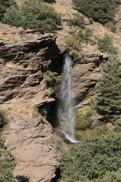 シエラネバダの渓谷の滝は 茂みがあり 岩や石があります — ストック写真