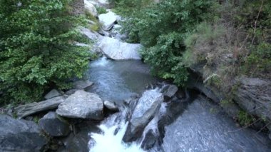 Güney İspanya 'da Sierra Nevada' da bir nehirden akan su, taşlar ve kayalar var, bitki örtüsü var.