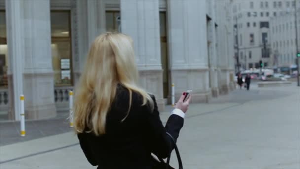 Atractiva rubia mujer de negocios usando teléfono inteligente viajero en la ciudad de Chicago — Vídeo de stock