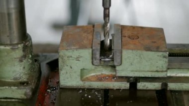 the Mechanism of the Machine Makes It`s Rod Spin and Drill a Hole in a Detail. in the Iron Detail Formed a Hole, the Detail Was Covered With Rust/