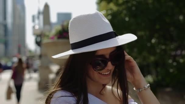 Smart Woman Stands Near Stone Fence and Twirls Hair by Her Hands. — Stock Video