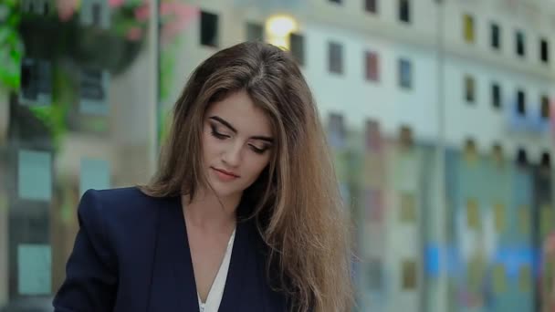 A Young Girl Standing Near the Office, Raises His Head and Smiling. — Stock Video