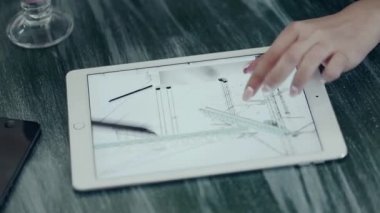 Dijital tablet ve kapuçino ahşap bir masa üzerinde tutan adam