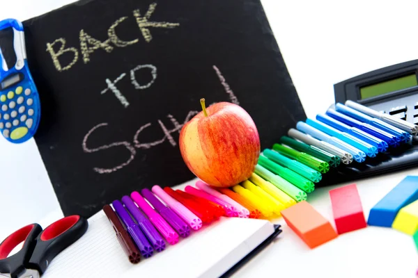 Back to school supplies and an apple for the teacher — Stock Photo, Image