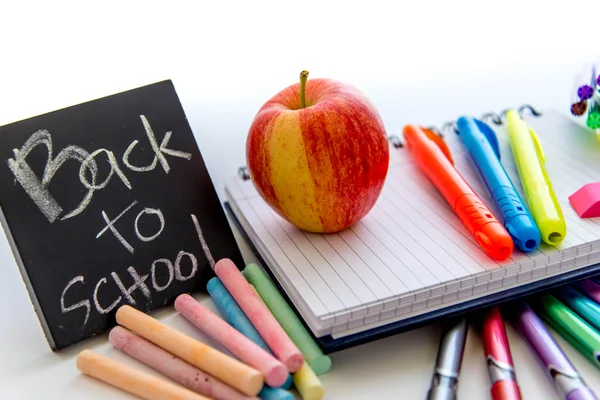 Back to school supplies and an apple for the teacher — Stock Photo, Image