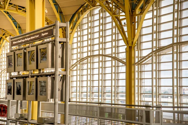 Passagiere gehen durch einen hellen Flughafen — Stockfoto