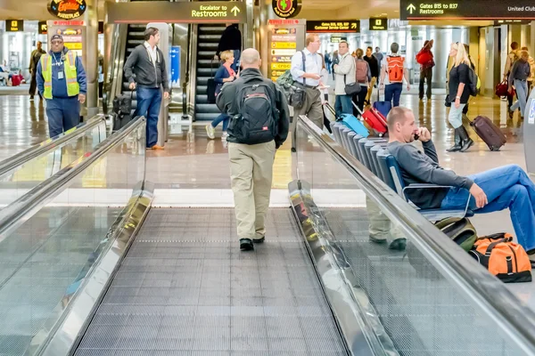 Daylighting roof structure with people walking and people movers — Stock Photo, Image