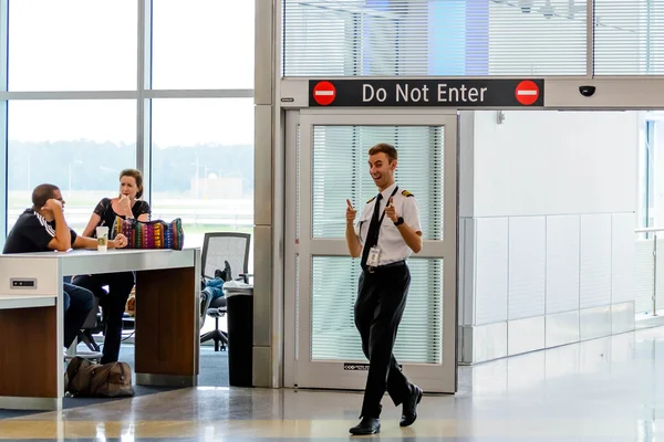 Flight personnel giving the thumbs up entering the boarding gate — Stock Photo, Image