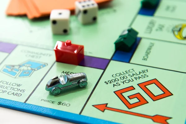 Monopoly board game in play — Stock Photo, Image