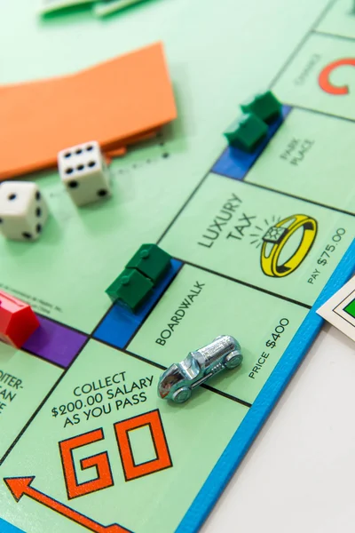 Monopoly board game in play — Stock Photo, Image