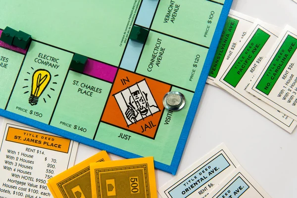 Monopoly board game in play — Stock Photo, Image