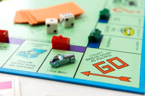 Monopoly board game in play — Stock Photo, Image