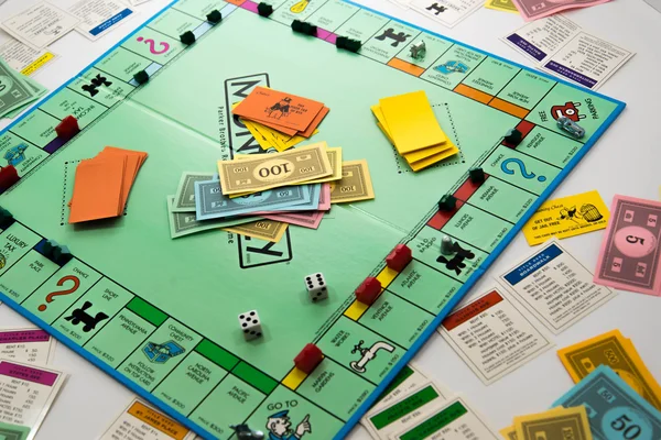 Monopoly board game in play — Stock Photo, Image