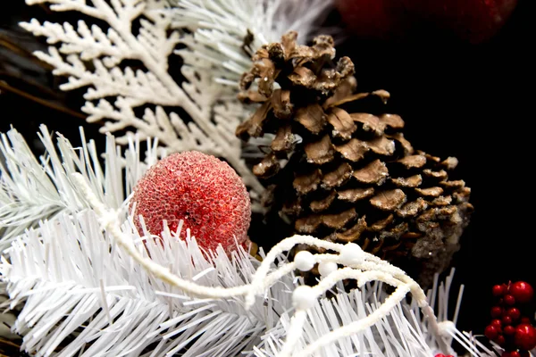 Christmas decorations - red ornament and brown pinecone in white — Stock Photo, Image