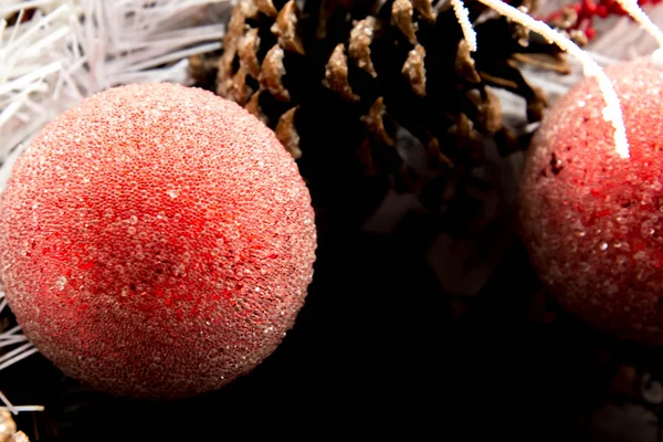 Christmas decorations - red ornament and brown pinecone in white — Stock Photo, Image