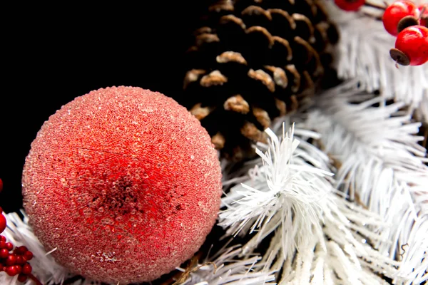 Christmas decorations - red ornament and brown pinecone in white — Stock Photo, Image