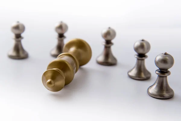 Chess game - pawns circled around a fallen king — Stock Photo, Image