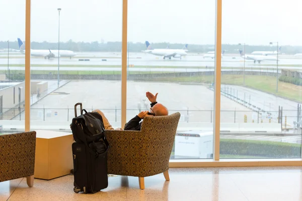 Passengers sitting with lugagge in airport — Stock Photo, Image