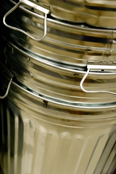 Stack of shiny new steel garbage cans — Stock Photo, Image