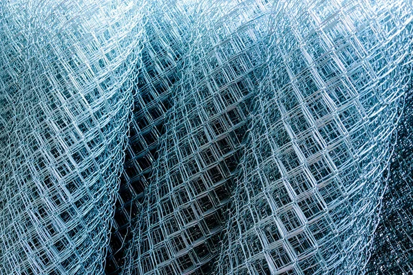 Rolled supplies of shiny new chain link fence — Stock Image Rolled supplies of shiny new chain link fence Royalty Free Stock Photos