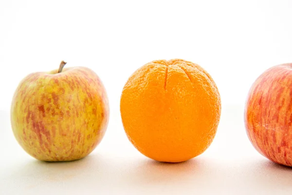 Line of apples with one orange — Stock Photo, Image